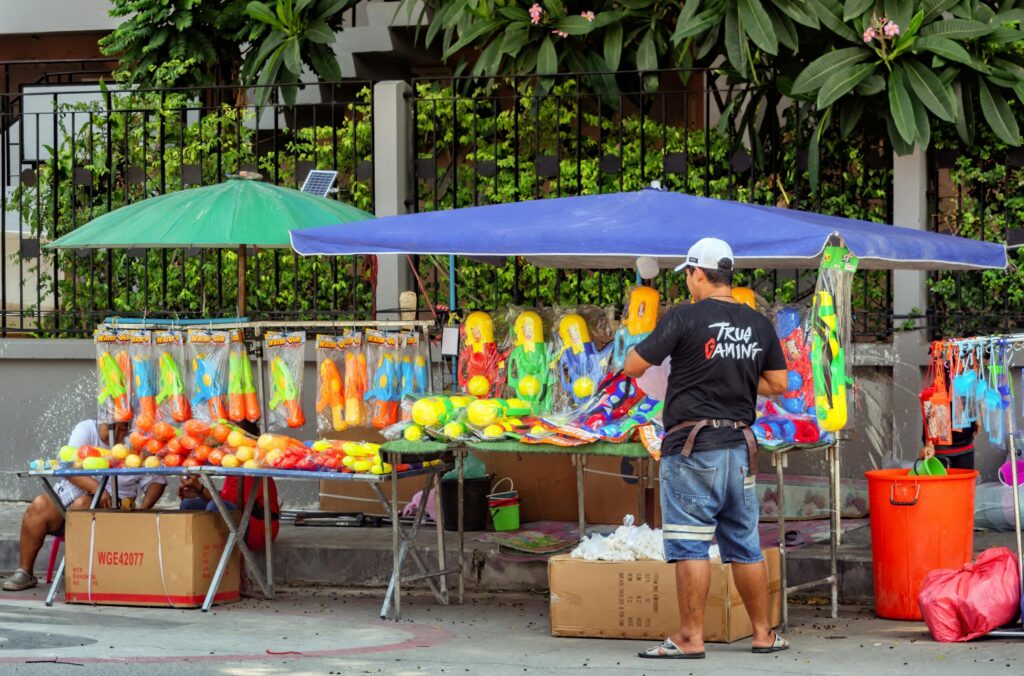 A street vendor sells colorful toys.
