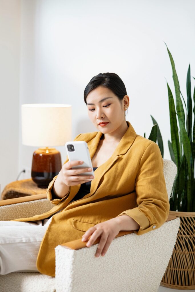 Asian woman explores her loan options through her phone. The Credit Kaagapay app helps her in her financial decisions.