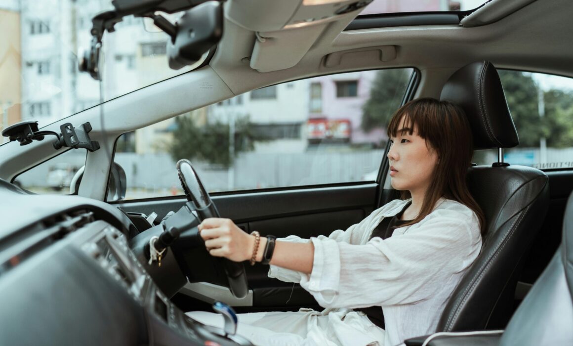 A girl is behind-the-wheel trying to pass her driver's license.