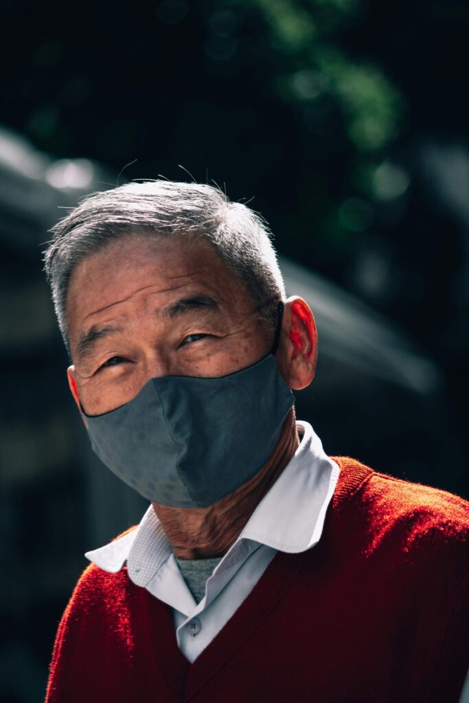 old man with face mask and red smiles  