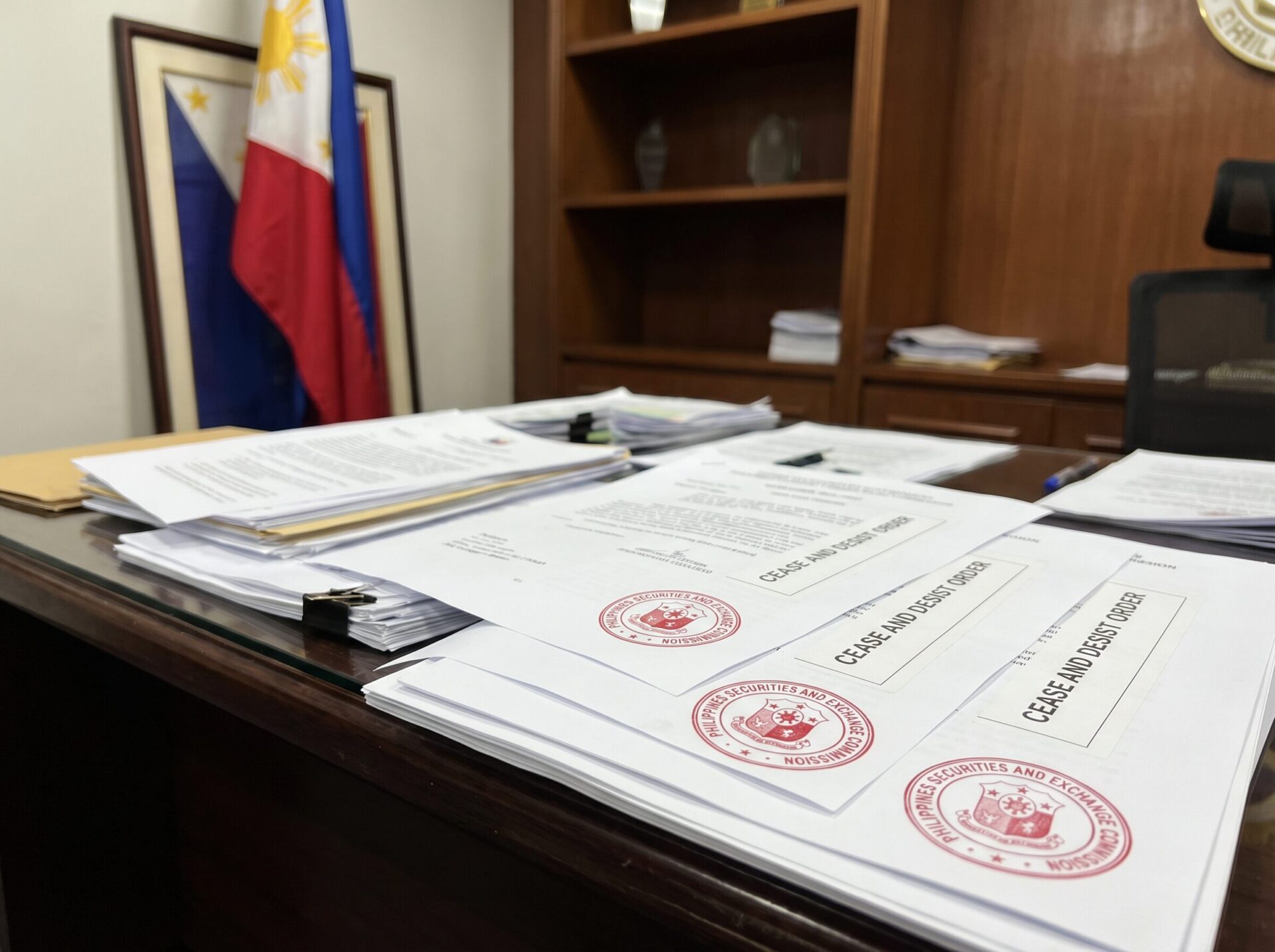 SEC enforcement documents and cease-and-desist orders with Philippine flag